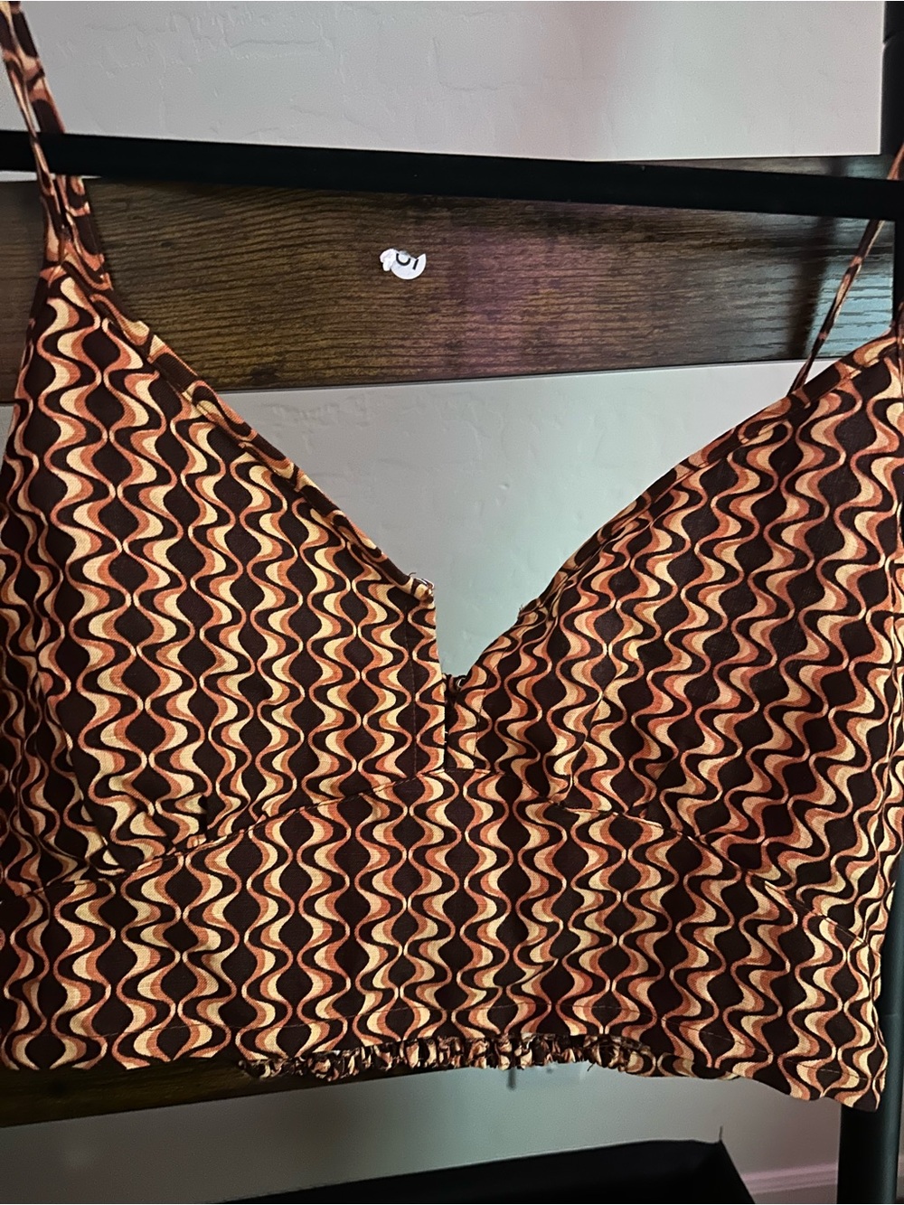 RVCA Moxy tank top featuring a retro brown and orange wavy abstract print.